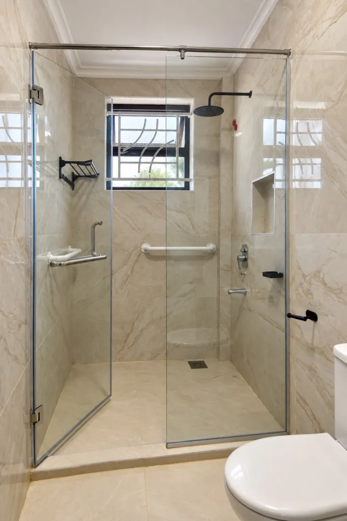 Walk-in glass shower with grab rails and a recessed niche, Kilimambogo home renovation