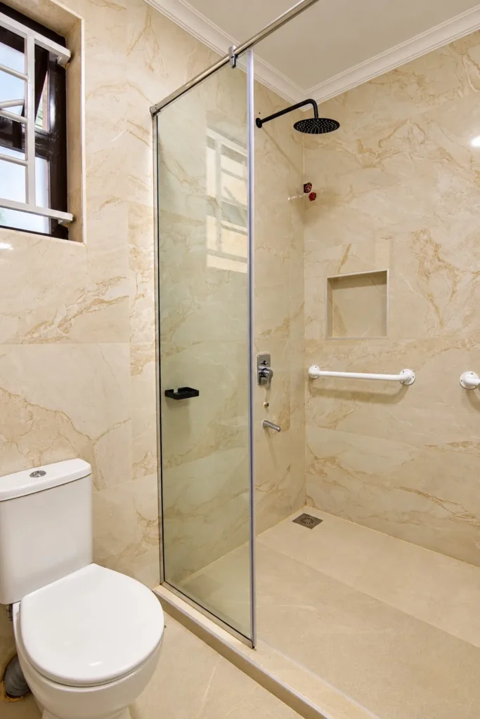 Corner glass shower with rain head, niche and grab bar, Kilimambogo bathroom renovation
